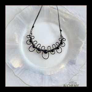 elfin alchemy sculptural squiggle necklace with black onyx and agate gemstone beads handcrafted in Lancashire