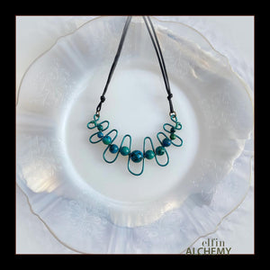 elfin alchemy sculptural squiggle necklace with teal /dark turquoise dyed Magnesite gemstone beads handcrafted in Lancashire