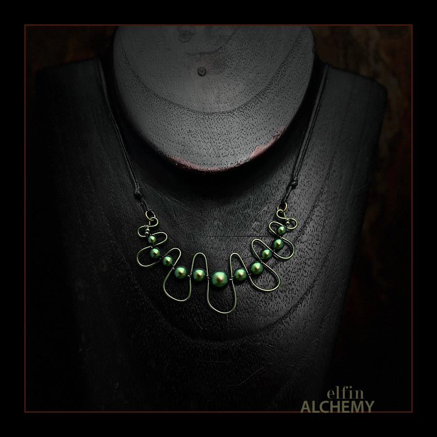 elfin alchemy emerald, verdigris and moss greens sculptural squiggle necklace with Swarovski pearls handcrafted in Lancashire