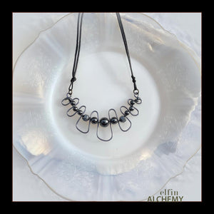 elfin alchemy sculptural squiggle necklace with metallic grey Hematine gemstone beads handcrafted in Lancashire