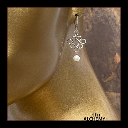 elfin alchemy sterling silver byzantine scroll earrings with white freshwater pearl beads, inspired by the magical art of our ancient ancestors, handmade in Lancashire, England