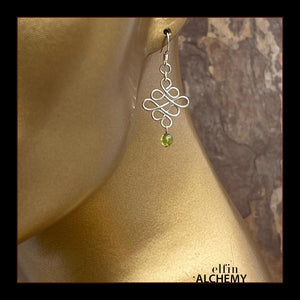 elfin alchemy sterling silver and green sculptural Celtic style peridot gemstone earrings inspired by the magical art of our ancient ancestors, handmade in Lancashire, England