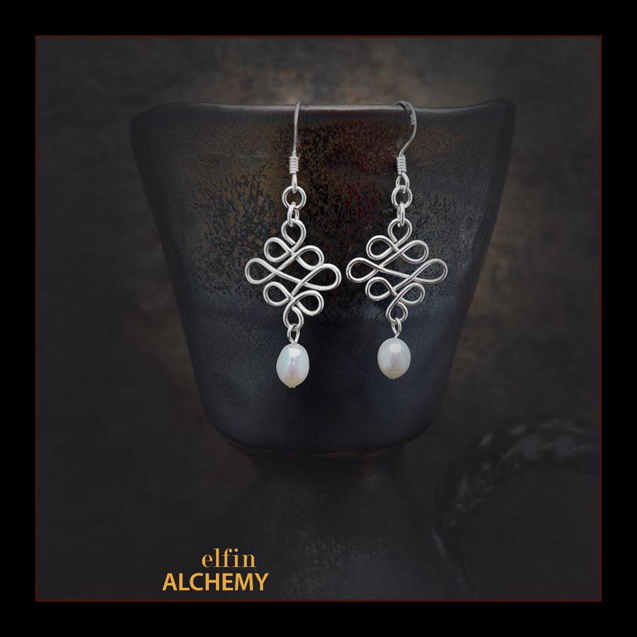 elfin alchemy sterling silver sculptural Celtic style white freshwater pearl earrings inspired by the magical art of our ancient ancestors, handmade in Lancashire, England