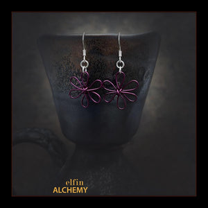 elfin alchemy dark purple sculptural flower style earrings inspired by the magical art of our ancient ancestors, handmade in Lancashire, England