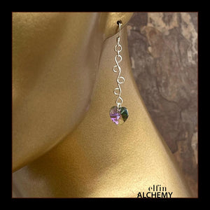 elfin alchemy sterling silver sculptural vine scroll earrings with purple/green colour Swarovski crystal hearts, inspired by the magical art of our ancient ancestors, handmade in Lancashire, England